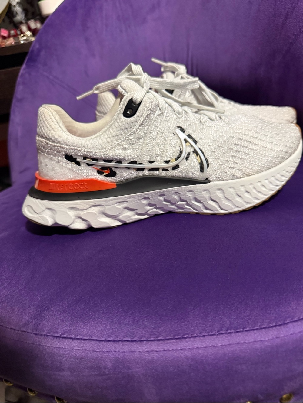 Nike White Running Shoes with Black Leopard Swoosh and Orange Heel